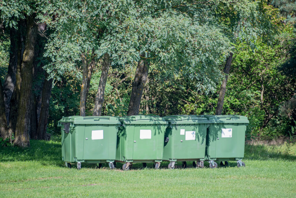 Dumpster bins in a park.